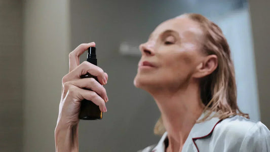 women using a serum spray on face