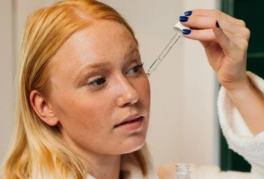 women applying eye serum