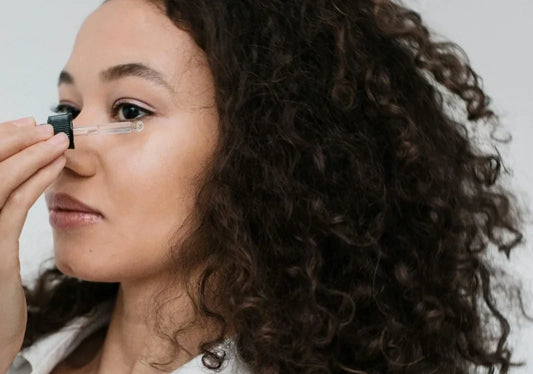 women using eye serum