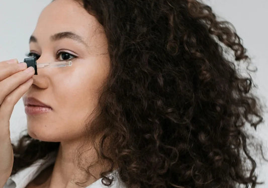women using eye serum